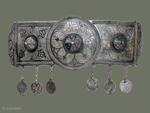 Silver Belt Buckle from Central Asia-

This handsome silver belt buckle is attractively decorated with floral patterns which are accented with 'niello' (an oxidation technique for silver). Three conical shapes provide distinctive ornamentation  ...