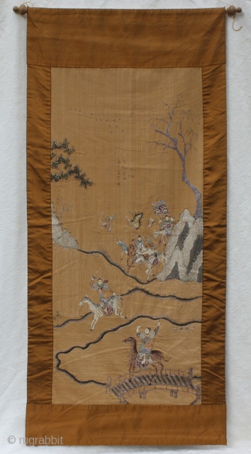 TC375  This antique Chinese silk textile wall hanging is embroidered with mounted soldiers carrying banners across a mountainous terrain. Silk background fabric with a wide silk border, the tapestry is approx  ...