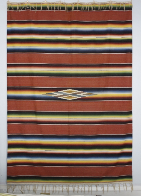 This traditional Mexican Serape textile measures 64 x 84 inches. Fibers are cotton and fine wool with "eye of god". Excellent quality and condition         