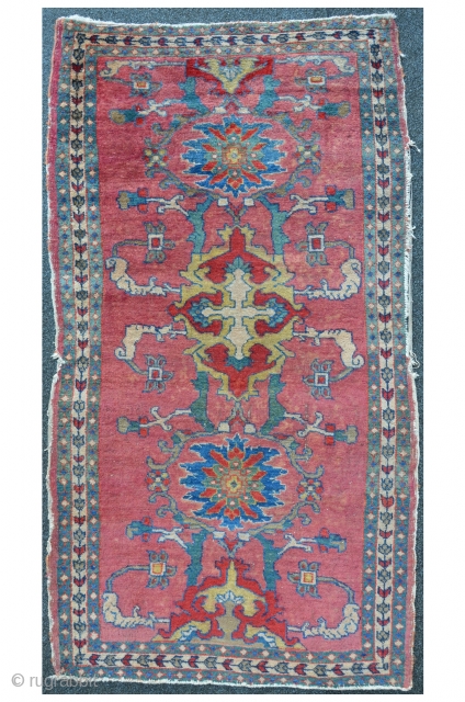 Antique Malayer with rare field design on pink ground, beautiful turquoise green border. 145 x 78 cm                