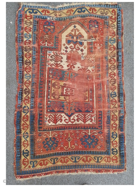 Fachralo Prayer rug. 100 x 157 cm, second half 19th. A damaged beauty in as found condition.                