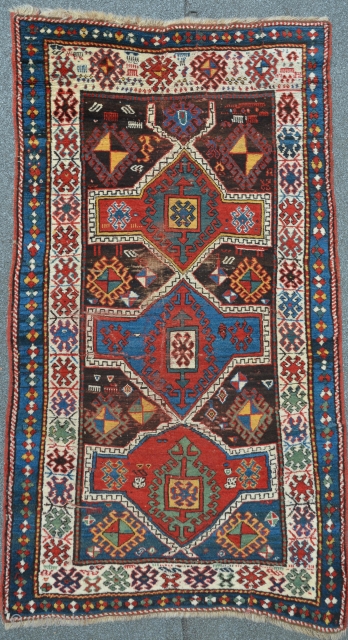 Lovely Kazak from south Georgia / Caucasus. Beautiful abrash in the outer blue-green border. High floor, but some places much worn, 191 x 107 cm        