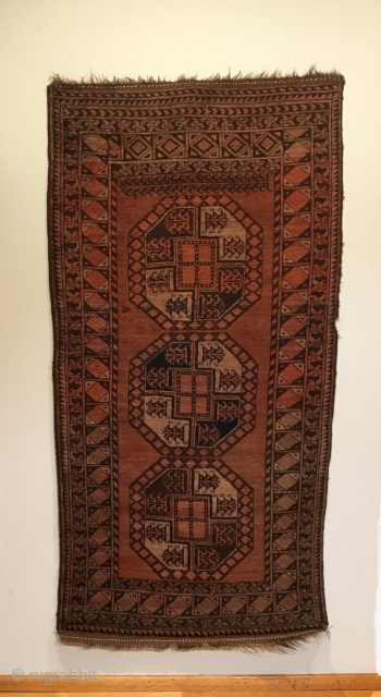 Old Afghan Qarqueen. Rich Madder-Brown abrashed field.  No secondary guls. Note: the special elongated Sulayman gul spanning top of field.  Full pile. Small bite to selvage and quarter sized moth  ...