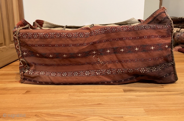 Antique Yomud Chuval. 19th Century. It is rare to find complete storage bags as many have been dismembered due to harsh conditions of seasonal migration. Sides feature a stepped hooked gul. Rear  ...