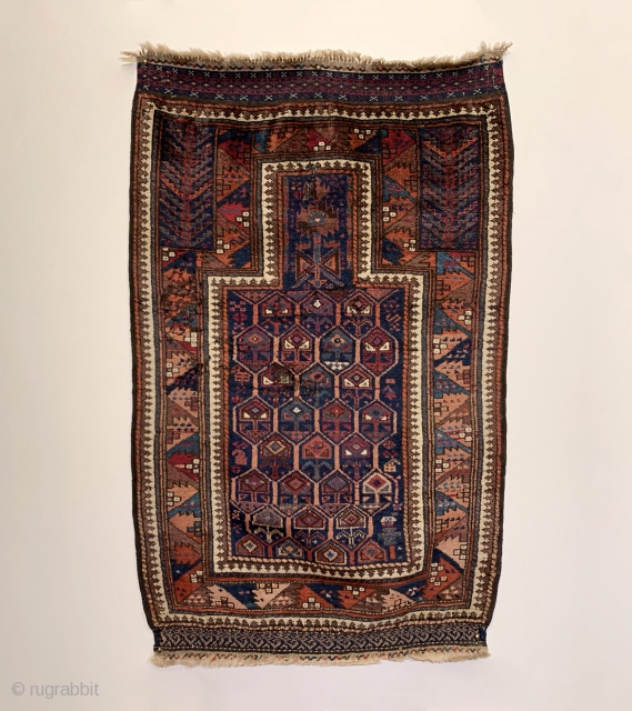 A rare and spectacularly colored Timuri Prayer Rug dating to the Mid 19th Century. Please note the use of color, specifically steel blue, peach, and purple. The honeycomb field is enclosed by  ...