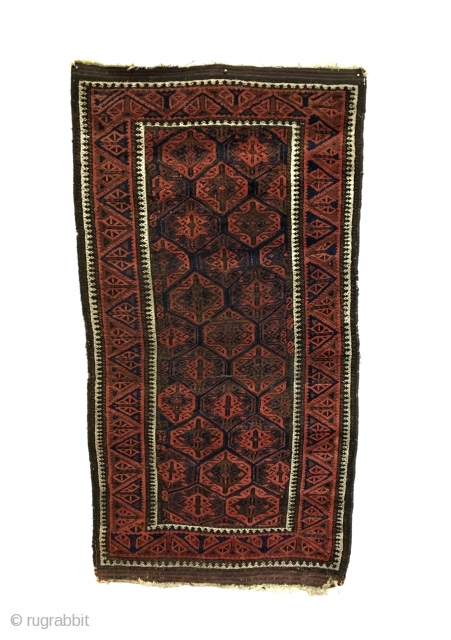 Antique Baluch Rug. Timuri, Sangtshuli. 3rd Quarter 19th Century. This is an early collectors rug. The main border consists of alternating triangles of tulip like three stemmed plants. Bright white medakhyl (medical)  ...