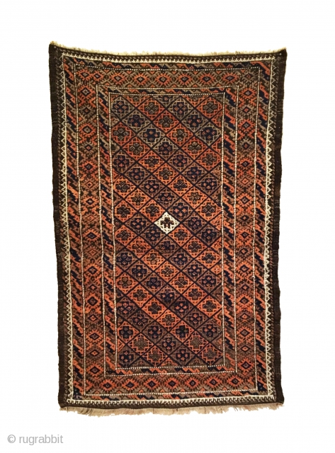 Antique Baluch Rug. Late 19th Century. Saturated colors. Soft, lustrous wool. It features an all-over diagonal diamond lattice field design enclosing crosses with a central ivory focal point. Slight brown corrosion enhances  ...