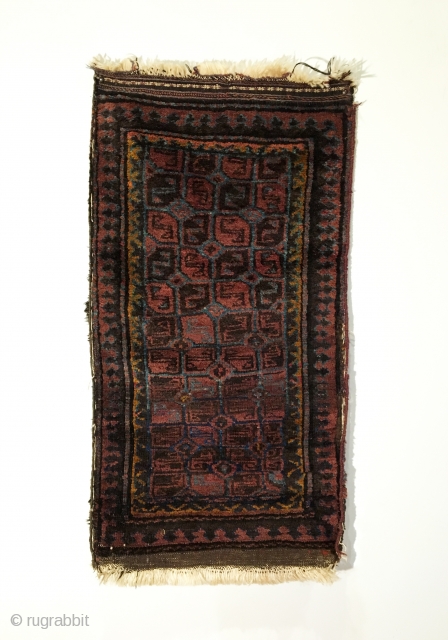 Small Afghan Baluch Rug.  Circa Antique.  5x2 gul patterned field.  Full lustrous pile.  One small hole.  5 colors.  40.5 x 22.  Clean and hand washed. 