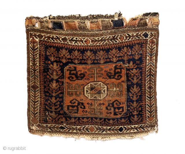 Antique Baluch Bagface. Northeast Persia. 2nd Half 19th Century. Shrubs and S design on blue field surround Tukoman like Gol with quartered dragon elements. Interesting white ground border. Original condition. Nice wall  ...