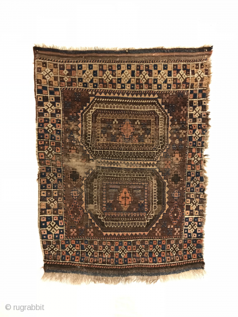 Antique Baluch Rug. 
Rare design, Turkoman influenced. Two siamese turreted gols float on saturated brown field. Stepped diamonds with abstract crosses fill center. Great condition considering age. Selvage loss to right side.  ...
