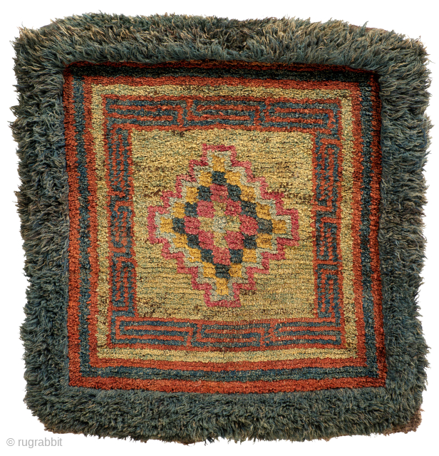 A monastic sitting mat with concentric checker motif with central Tigma is an uncommon design to be found on Wang-den carpets. 
Late 19th
Tibet

tmond @ hotmail.com        