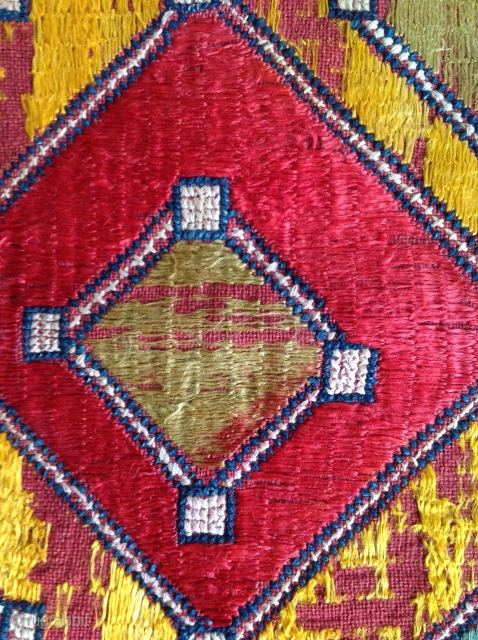 Indian embroidery. Cotton ground with silk embroidery in Phulkari technique. Cotton cross stitched border. Small hole in centre. 12 x 13 inches
Early 20th Century.         