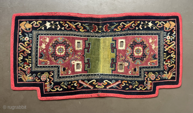 Makden (under saddle rug), South Central Tibet, probably around 1900, 128 x 64 cm, the main field was likely dyed with Indian lac, the central border consists the Eight Taoist Symbols of  ...