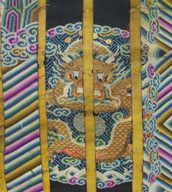 An old dragon robe, uncut panel with wonderful motif and colors. Silk woven with gold metallic wrapped thread, double sided and with silk backing. Late 19th c. Size: 2mx 60cm. Click for  ...