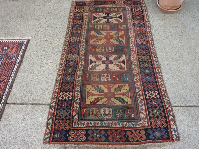 SOLD   THANK YOU!   Antique Caucasian pile rug in somewhat distressed condition.  Unusual pattern and a rich array of intriguing colors and designs,  Rings on back indicate  ...