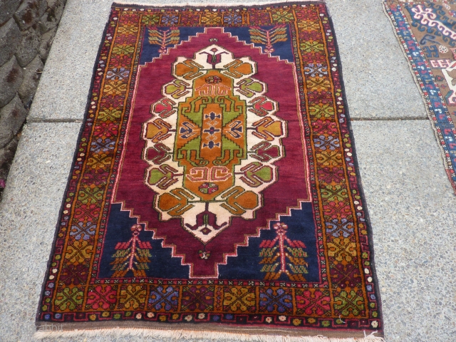 Decorative semi-antique Turkish rug in excellent condition 49" x 70" dazzling colors in border.                   