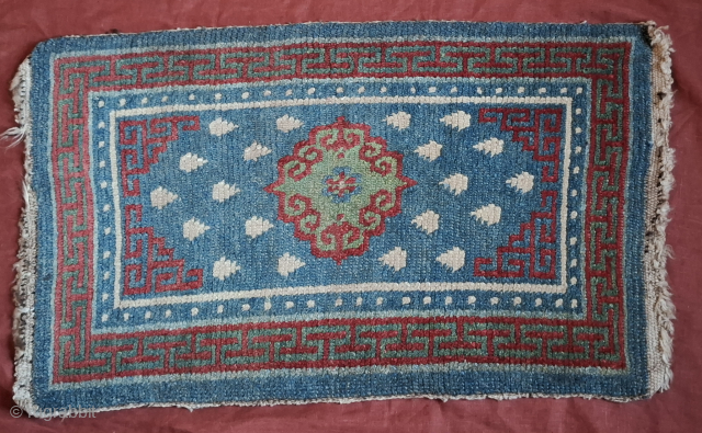 A stunning Khamdrum from mid 19th century or earlier. Both wool and dyes are sensational. 95x57 cm.

One of the best tibetan rugs I've had the pleasure to handle. Sourced in Tibet in  ...