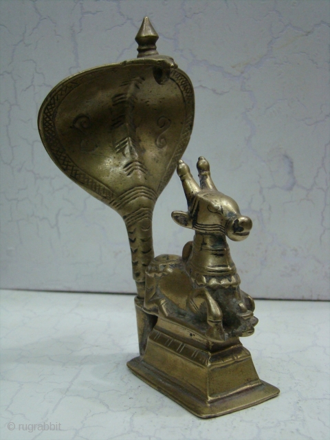 Brass Nandi Statue The 'vahana' or carrier of Shiva With Cobra Snake, 

The Nandi Bull is always to be found facing the 'shivalingam' in places of worship. Nandi represents the creative energies  ...