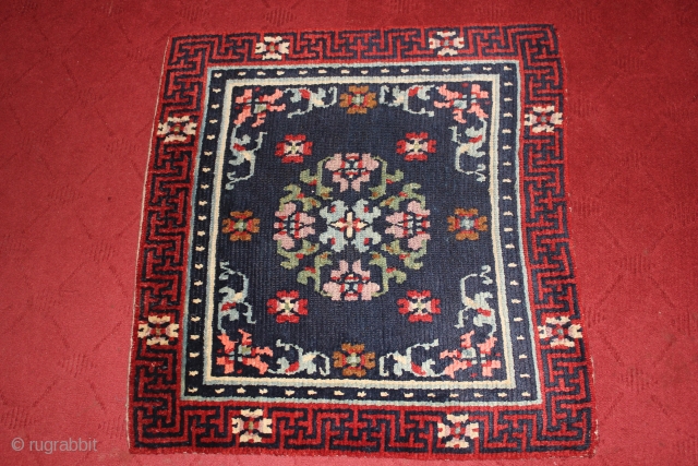 Antique Tibetan Meditation rug featuring A Beautiful medallion in indigo background surrounded with White pearl(Norbu). The border is very beautiful with flowers on it too.        