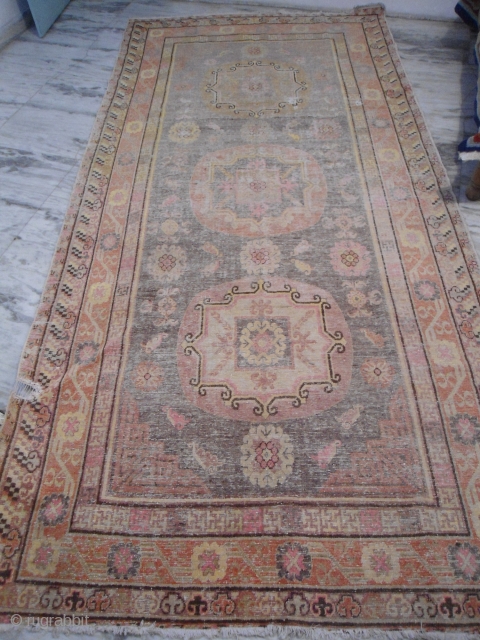 20th century Khotan, East Turkestan  rug
5 ft x 12 ft
short pile, worn areas, synthetic colors
                 