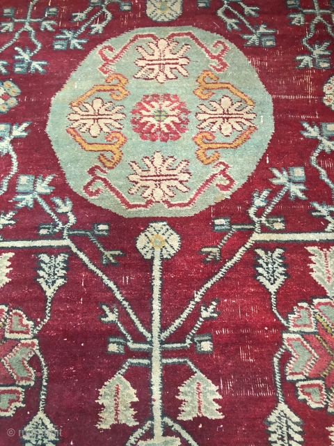 Pair of Khotan fragments, each 32" x 35", cut from a large early 19th c 3 medallion Tarim Basin carpet.
Condition good for age with areas of thinning. well saturated, compelling shale green  ...