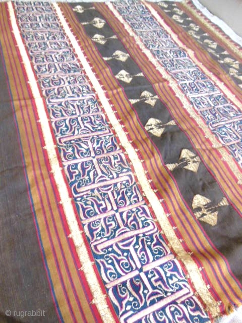 Lampung ceremonial cloth from Indonesia, South Sumatra 19c .Woven striped background cotton in shades of red madder, indigo, yellow and brown. Red and white silk embroideries with geometric patterns on indigo background.  ...