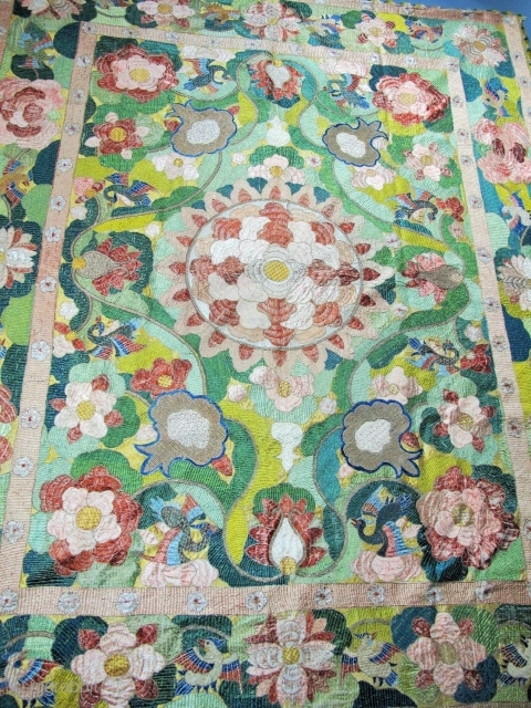 ​Chinese for export to Portugal
Silver and polychrome silk floss embroidered hanging in the Chinese manner. A large central peony is framed by pairs of birds, lotus flowers, clouds and phoenix, all derived  ...