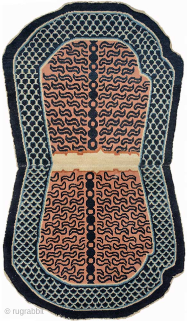 Large tiger striped under-saddle carpet made in the Xinjiang region of western China.The tiger stripes emanate out from a stylised backbone while the main border features dragon scales. Made circa 1930, the ...