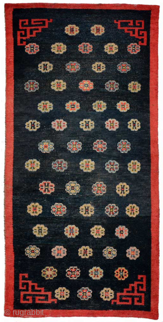 Impressive Tibetan khaden featuring multiple Khotanesque-like flower heads spread evenly throughout a deep indigo blue abrashed center field. All the dyes are natural, rich and saturated, the warp is cotton, while the  ...