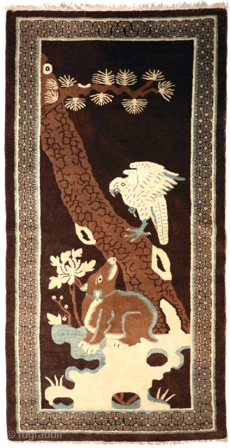 Unique pictorial carpet from the Baotou-Suiyuan region of China depicting a hawk or eagle resting on a gnarled old tree staring down a tapir (which once existed in ancient China), a not  ...
