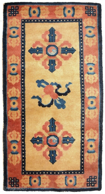 Symbolically powerful carpet from the Ningxia region of China featuring in the center field a pilgrim’s, or truth-seekers, gourd and staff between two double, or crossed, dorje's (visvavajra’s), both with the yin  ...