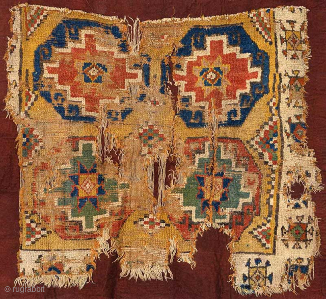 Outstanding eighteenth century carpet fragment from the Cappadocia region of Turkey featuring the so-called 'Memling gul’. This impressive fragment is mounted on an intentionally rustic maroon felt backing the size of which  ...