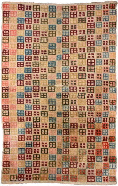 Slightly over-sized Tibetan khaden, although not quite sapden size, featuring rows of window-like motifs (a very early version of Windows 95 maybe?) in a multitude of subtle colours on a lustrous wool  ...
