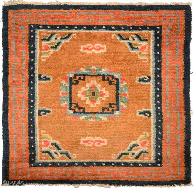 Beautiful Tibetan seating square featuring a mandala like center motif afloat in a light 'goldish-brown' field sparingly decorated with clouds, with the mountain motif anchoring the four corners. The main outer border  ...