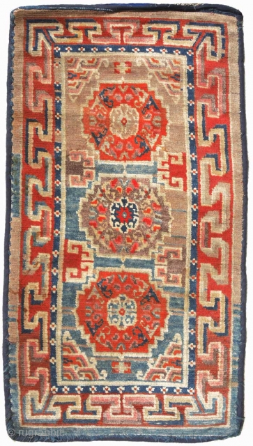 Funky old Tibetan khaden with three mandala medallions and an outer three-dimensional ‘T’ border, while the inner border is decorated using the tigma (crosses) design. Loose floppy village weave made in the  ...
