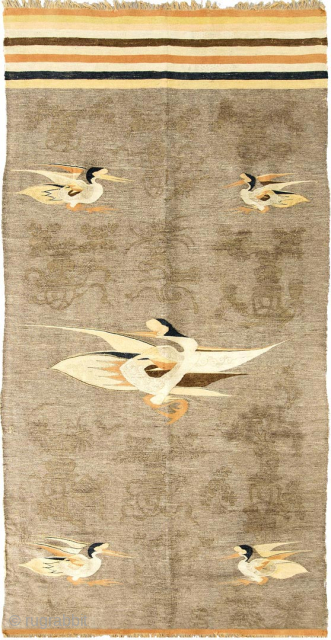 So-called 'Gansu-kilim' from China. This piece vividly displays the wood block print designs scattered throughout the natural undyed wool of the main-field, and is adorned by five Manchurian cranes which are woven  ...