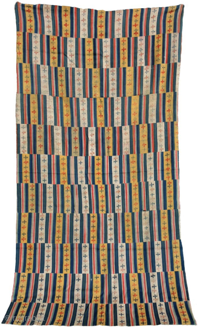 Large Tibetan or Bhutanese ‘blanket’ that, when used in Bhutan, was worn as a wrap around women's garment. Made of eleven striped multi-coloured panels – with yellow and off-white featuring the tigma  ...