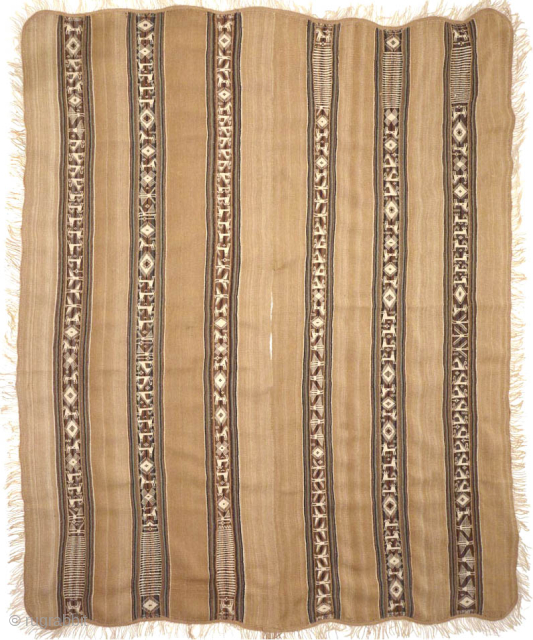 An exemplary ceremonial poncho from the Charazani village area, Department of La Paz, Bolivia, South America. The tan camelid fibre used in this piece comes from the Vicuna, a relative of the  ...