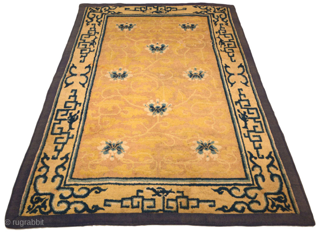 A very old Chinese carpet made in either the Ningxia or Beijing region in the 1700's / 18th century. The design in the golden-yellow center field is elegantly fashioned and features eight  ...