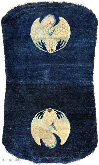 Somewhat unusual shaped saddle carpet made in the Baotou / Inner Mongolia region of China toward the end of the Qing Dynasty. It has a simple but elegant design featuring a single  ...