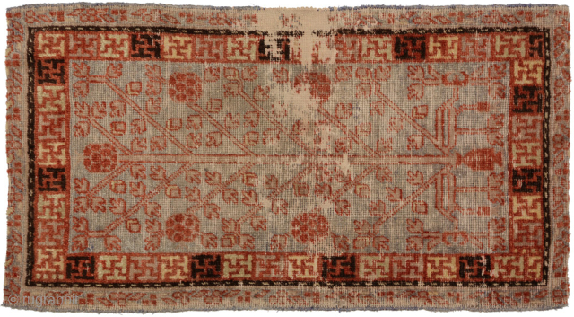Chinese carpet from one of the old Silk Road oasis towns of Xinjiang province, either Khotan or Yarkand, that has been used as an over-saddle carpet (or ‘masho’ in Tibetan). It features ...