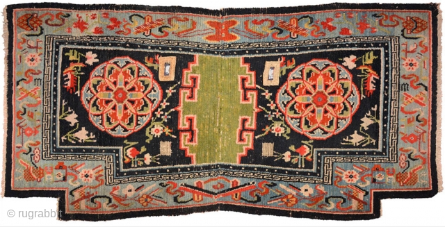 Tibetan under-saddle carpet or ‘makden’ with an uncommon main motif roundel, referred to by some as a Khotan roundel or a ‘Khotan influenced’ roundel (because of its likeness to similar motifs found  ...