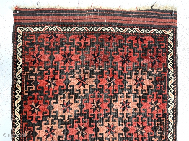 Antique small Baluch rug with very good design, excellent color and overall fair condition for the age. The array of archaic radiating medallions in diagonal bands on a lightly oxidized brown ground  ...