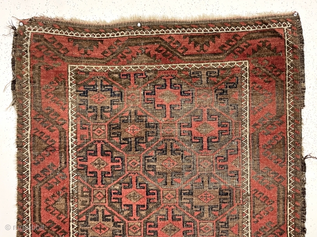 Antique little Baluch with classic tile design field. Interesting meandering vine border. All natural colors. Overall low pile with wear and brown oxidation as shown. Remnant original selvages and kelim ends. I  ...