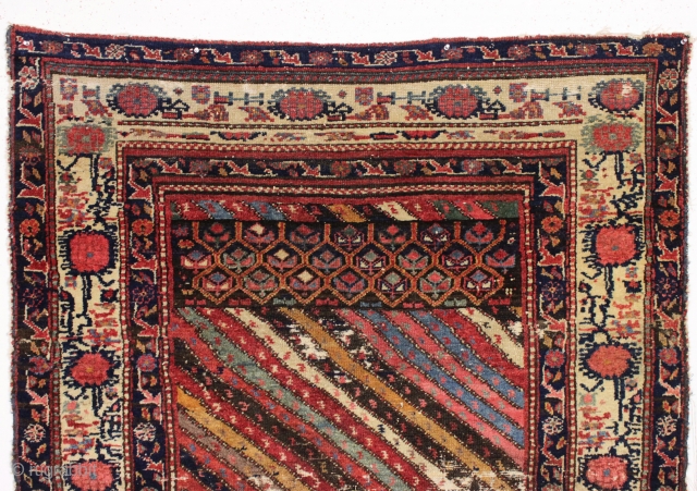 Large fragment of both ends of a beautiful old northwest Persian rug. Interesting design and all natural colors featuring a lovely old purple. Reasonably clean. ca. 1875. 4'4" x 5'10"   