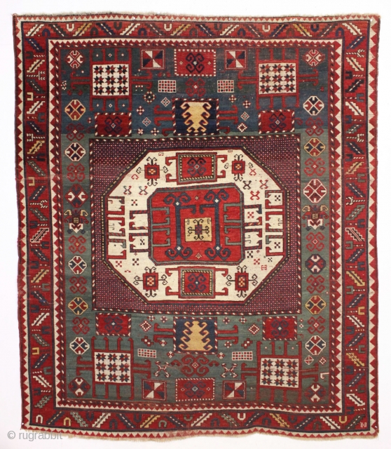 antique karachopf kazak. Untouched, unrestored large classic kazak. All natural colors featuring a beauiful abrashed green field, good reds, multiple blues and a fine old yellow. Pile varies from good thick medium  ...