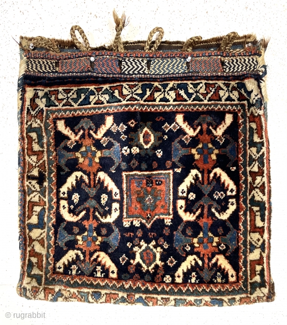 Antique complete south Persian bag. Mostly good thick high pile. All natural colors. Original fancy closure tabs and colorful back. Reasonably clean. Nice example of the type. Late 19th c. About 24”  ...