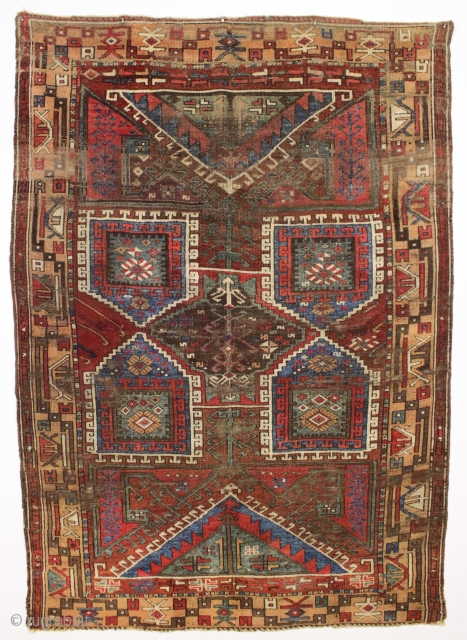 Early turkish village rug. Archaic. Beautiful natural colors. Old piece with scattered small repairs of varying quality. First half 19th c. 5'1" x 7'3"         