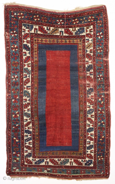 antique kazak rug with an eye catching empty field. Mostly good pile. As found, a bit dirty with scattered slight wear, few very small holes and creases as shown. Original selvages and  ...