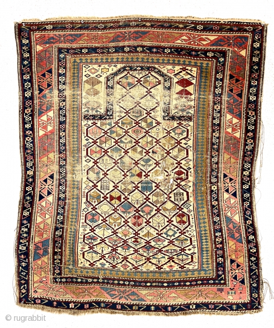 Early ivory ground shirvan prayer rug with unusual elements and extremely saturated natural colors. Some lattice elements are unusual if not unique. Unfortunately the rug is in very rough condition with areas  ...